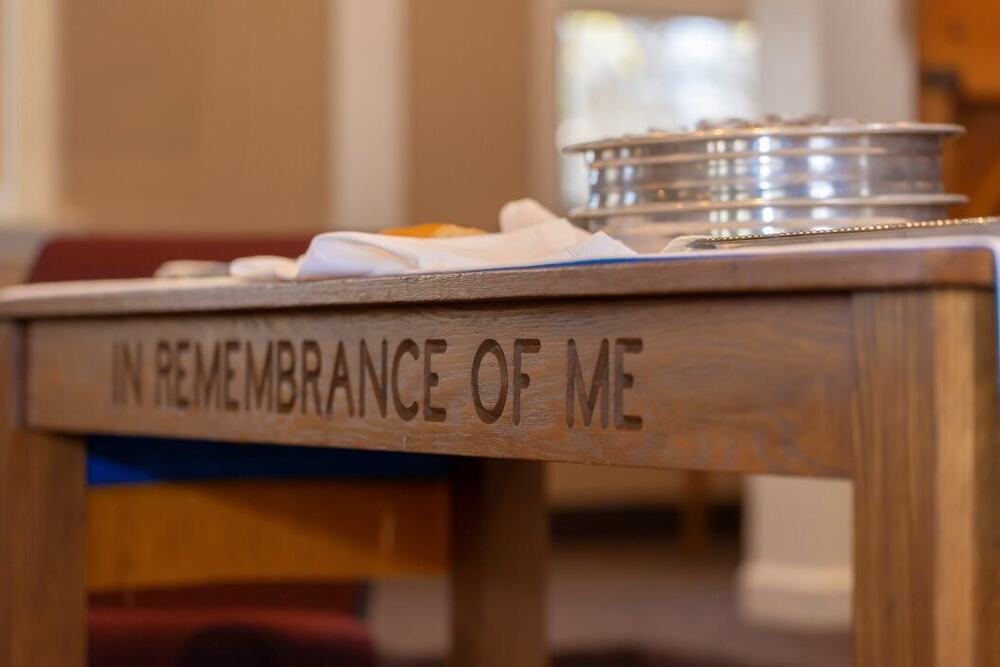 An elder serves communion to the congregation at Faith Reformed Church